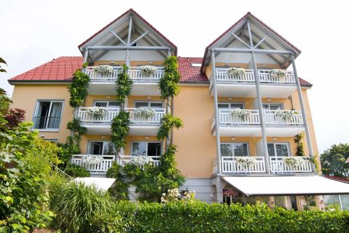 a large yellow building with white balconies at allgovia hotel garni in Wangen im Allgäu