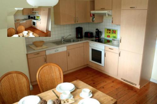 a kitchen with a table and chairs and a kitchen with white appliances at Große Ferienwohnung Klosterklause Malchow in Malchow