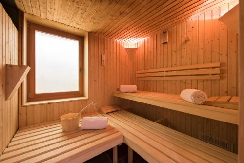 a sauna with two benches and a window at Chalet Shalimar in Zermatt