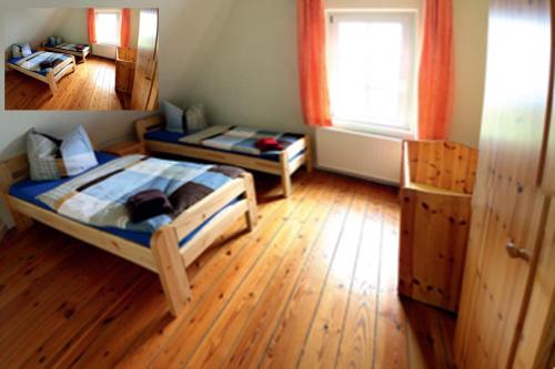 a bedroom with two beds and a wooden floor at Große Ferienwohnung Klosterklause Malchow in Malchow