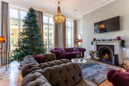 a living room with a christmas tree and a couch at Luxury Mansion Townhouse with Private Cinema in Brighton & Hove