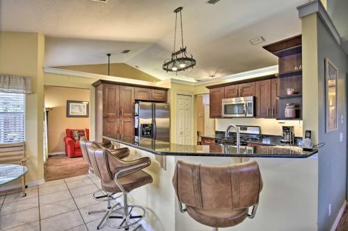 a kitchen with a island with bar stools at Cocoa Beach Paradise Screened Pool, Patio and Games in Merritt Island