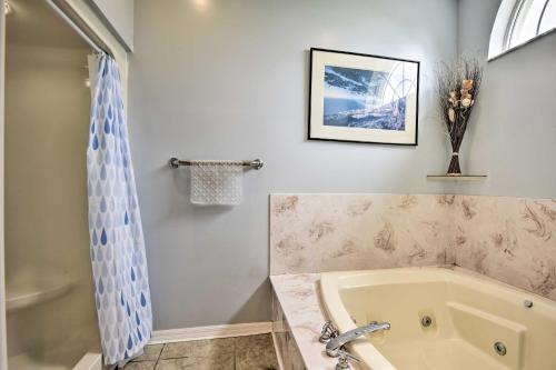 a bathroom with a bath tub and a sink at Cocoa Beach Paradise Screened Pool, Patio and Games in Merritt Island