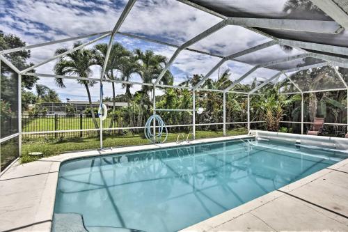 a swimming pool with a pergola and a swimming pool at Cocoa Beach Paradise Screened Pool, Patio and Games in Merritt Island