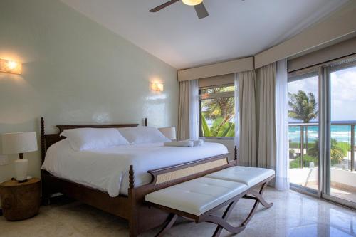 a bedroom with a bed and a large window at Villa Turquesa in Playa del Carmen