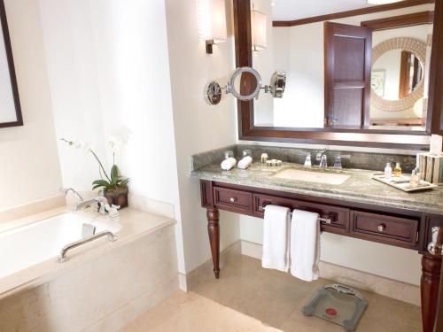 a bathroom with a sink and a tub and a mirror at InterContinental Costa Rica at Multiplaza Mall by IHG in San José