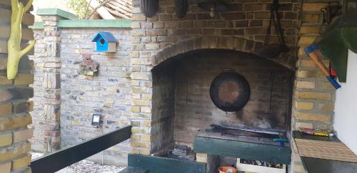 a brick oven with a pan on a brick wall at Vila Sava in Jarak