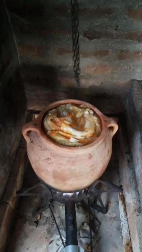 a pot of food cooking in a stove at Vila Sava in Jarak