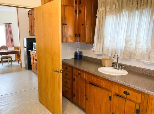 a kitchen with a sink and a counter top at Guest Ranch Motel in Cheyenne