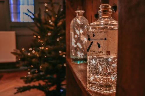 a bottle of alcohol next to a christmas tree at Black Bull Godmanchester in Huntingdon