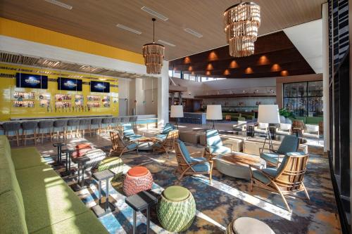 a lobby of a hotel with chairs and tables at Universal’s Endless Summer Resort – Dockside Inn and Suites in Orlando