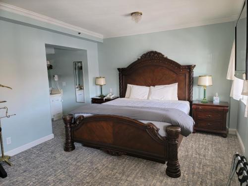 a bedroom with a large bed with a wooden headboard at Lowell Inn in Stillwater