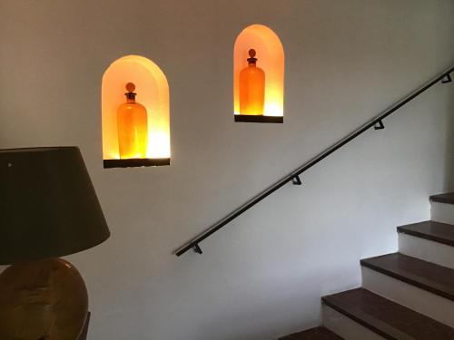 a set of three lights on a wall next to stairs at Mas de Fontclovisse in Draguignan