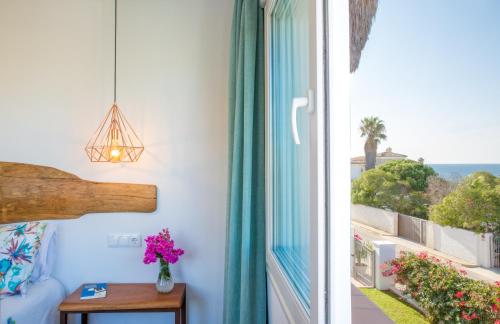 a room with a window with a view of the ocean at Fortuna in Los Caños de Meca