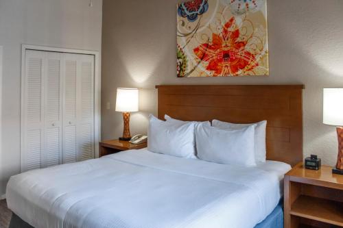 a bedroom with a white bed and two lamps at Hilton Vacation Club Polynesian Isles Kissimmee in Kissimmee