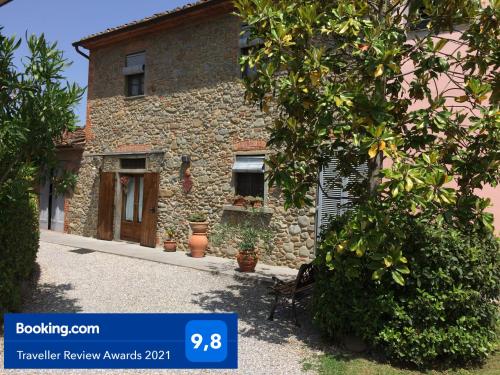 a stone house with a tree in front of it at La casa dei nonni in Larciano