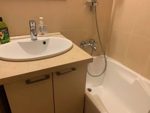 a bathroom with a sink and a bath tub at Comfortable Stay in Siauliai in Šiauliai