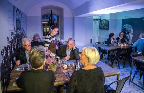 a group of people sitting around a table in a restaurant at Waterside Mariestad in Mariestad