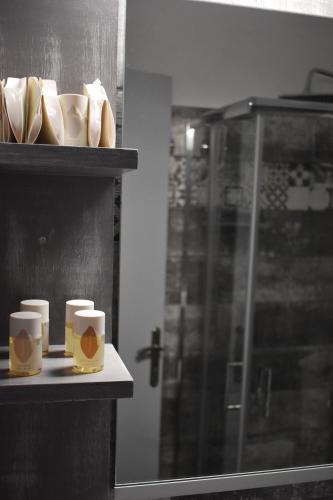 two coffee cups sitting on a shelf in a bathroom at Liprando in Naousa