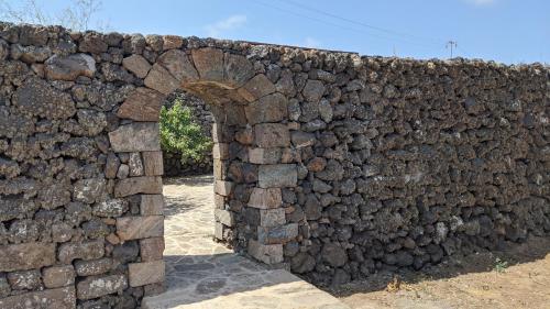 an old stone wall with an arch in it at Horizon Pantelleria in Pantelleria