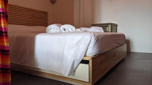 a bed with white sheets and towels on it at Horizon Pantelleria in Pantelleria