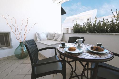 a table with two plates of food on a patio at Casa Boarni Leuca in Leuca