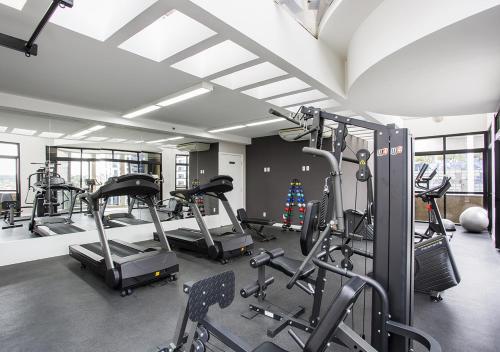 a gym with several treadmills and cardio machines at Estanplaza Funchal Faria Lima in Sao Paulo