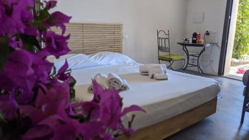 a bedroom with a bed with two towels on it at Horizon Pantelleria in Pantelleria