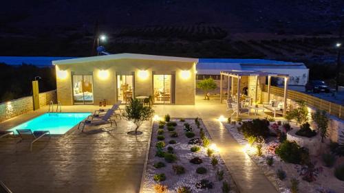 a villa with a swimming pool at night at 2 steps Falasarna beach-Liakos- Homeleader in Falasarna