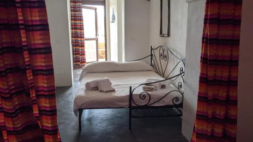 a small bed in a room with a window at Horizon Pantelleria in Pantelleria