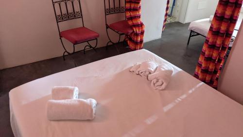 a bath tub with two towels and two chairs at Horizon Pantelleria in Pantelleria