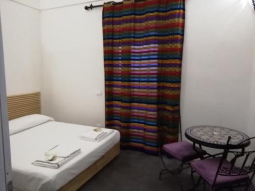 a room with a bed and a table and a curtain at Horizon Pantelleria in Pantelleria