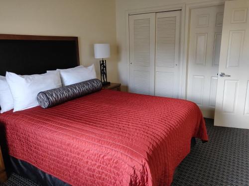 a bedroom with a bed with a red comforter at GetAways at the Lodge at Kingsbury Crossing in Stateline