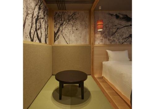 a small room with a bed and a table at Sakura Sky Hotel - Vacation STAY 18442v in Tokyo