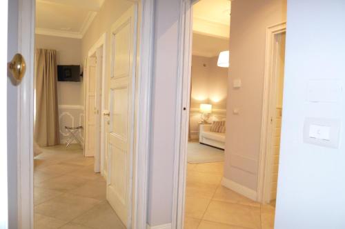 a hallway with a white door and a living room at Brunelleschi suite in Florence