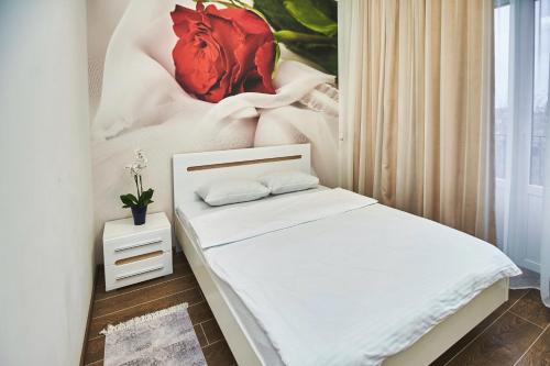 a bedroom with a bed with a painting on the wall at Ангел комфорт in Kyiv