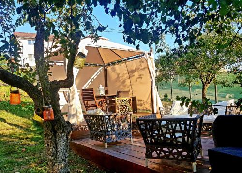 a gazebo with a table and chairs on a wooden deck at Vila Magnolia in Curtea de Argeş