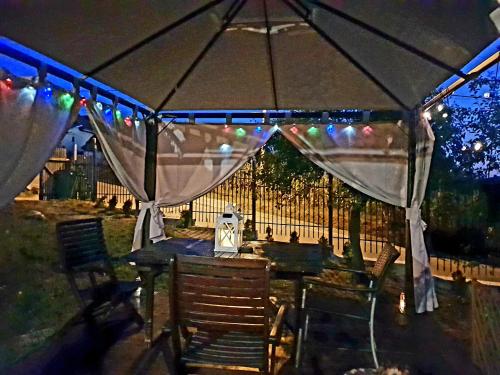 a table and chairs under a tent at night at Vila Magnolia in Curtea de Argeş