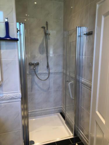 a shower with a glass door in a bathroom at L11 Ferienwohnung in Lahnstein