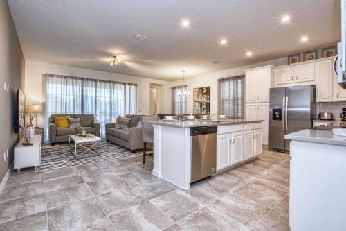a kitchen and living room with a couch and a table at 5 Bedrooms Townhome W- Splashpool - 8205Sa in Orlando