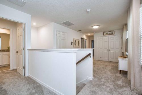 - une cuisine avec des murs blancs et un comptoir blanc dans l'établissement 5 Bedrooms Townhome w- Splashpool - 8205SA, à Orlando
