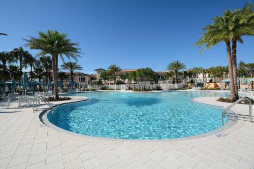 a large swimming pool with palm trees in a resort at 5 Bedrooms Townhome W- Splashpool - 8205Sa in Orlando