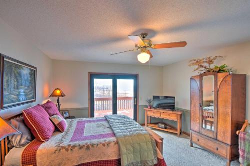 a bedroom with a bed and a ceiling fan at Home with Spacious Deck, BBQ, Game Room and Lake Views in Hiawassee