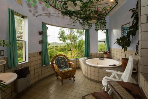 a bathroom with a tub and a large window at La Pasarela in Tarija