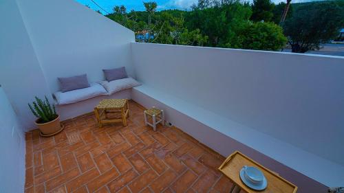 a balcony with a couch and a table at Ses Arcades in Sant Joan de Labritja