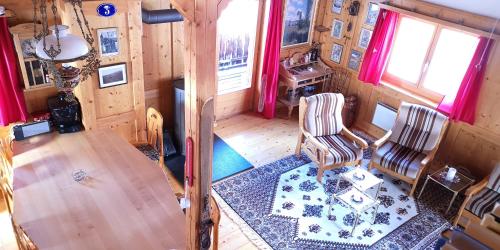 an overhead view of a living room with a table and chairs at grosses Ferienhaus mit Sauna im Skigeb. Obersaxen in Obersaxen