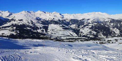 a snow covered mountain range with a ski slope at grosses Ferienhaus mit Sauna im Skigeb. Obersaxen in Obersaxen