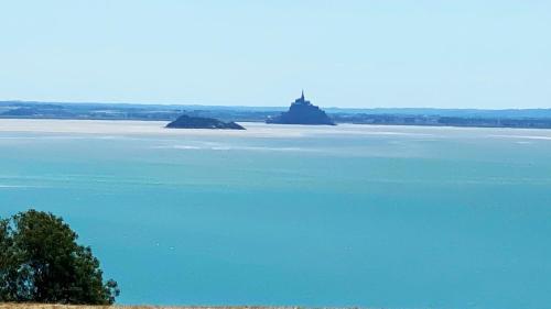 a large body of water with two islands in it at Maison de La Beslière meublé de tourisme 2 étoiles in Folligny