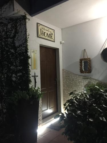 a front door of a house with a sign that reads home at The Incantation Guest House in Montesilvano