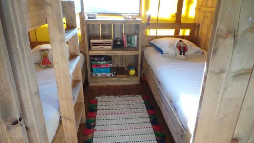 a bedroom with two bunk beds and a rug at Retour Au Source in Monprimblanc